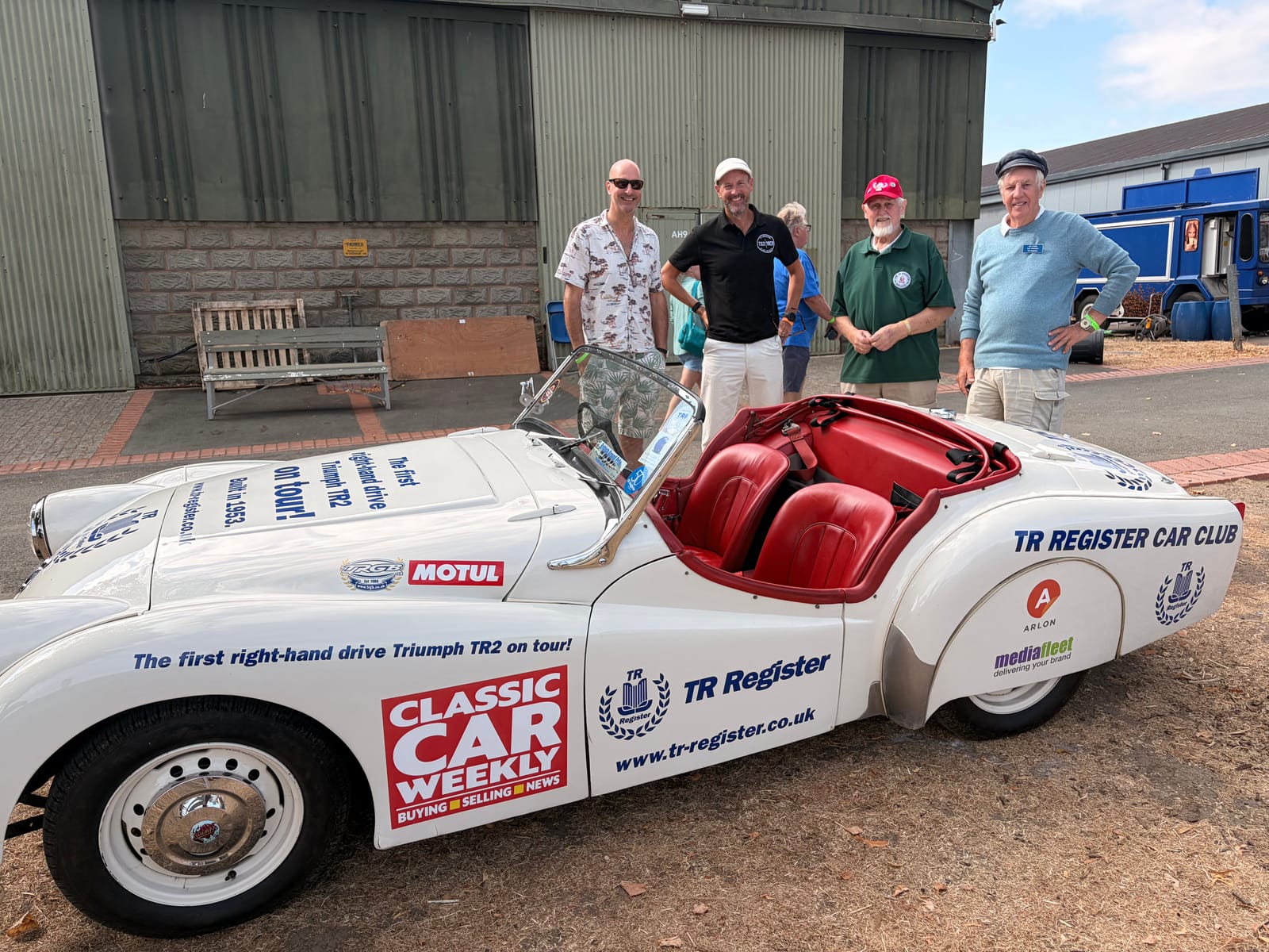 Left to right: James, Andy, Keith and Ian Evans standing beside TS2 with the bonnet up