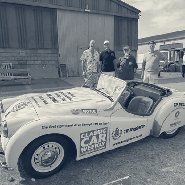 Left to right: James, Andy, Keith and Ian Evans standing beside TS2 with the bonnet up