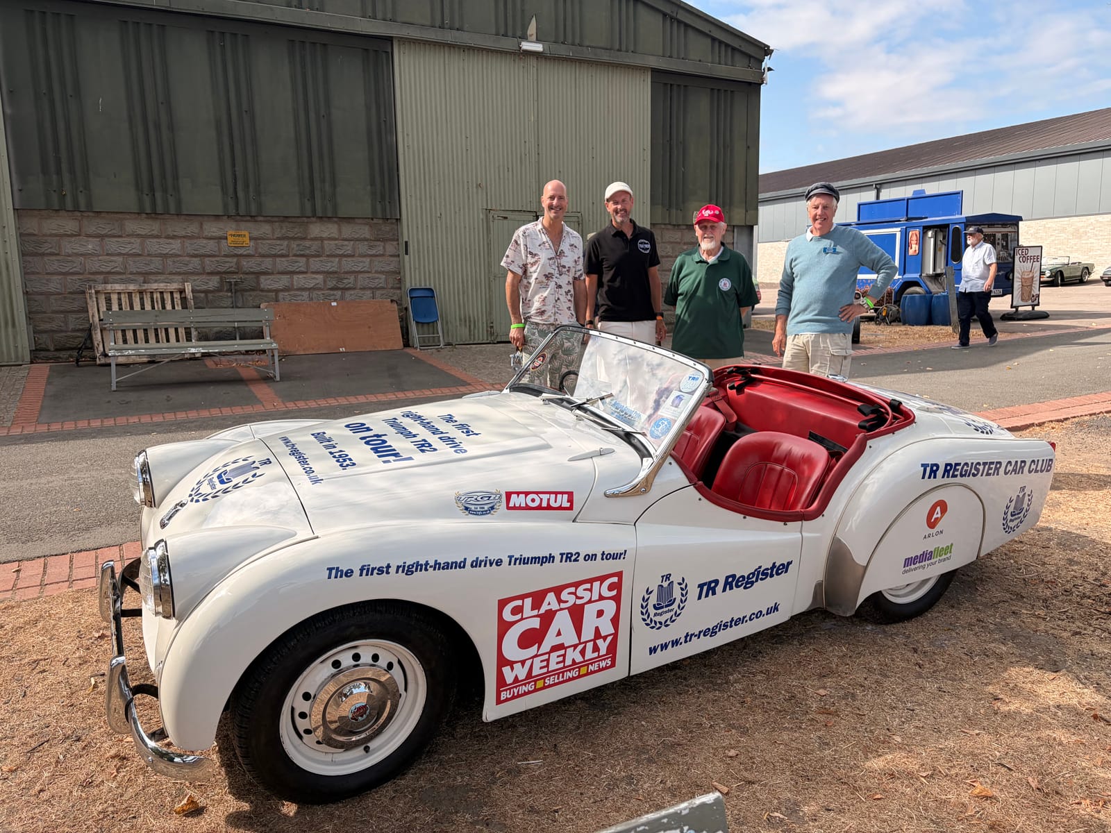 Left to right: James, Andy, Keith and Ian Evans standing beside TS2 with the bonnet up