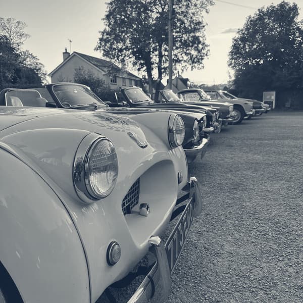 A line of TRs parked into the sunset at Bloxworth