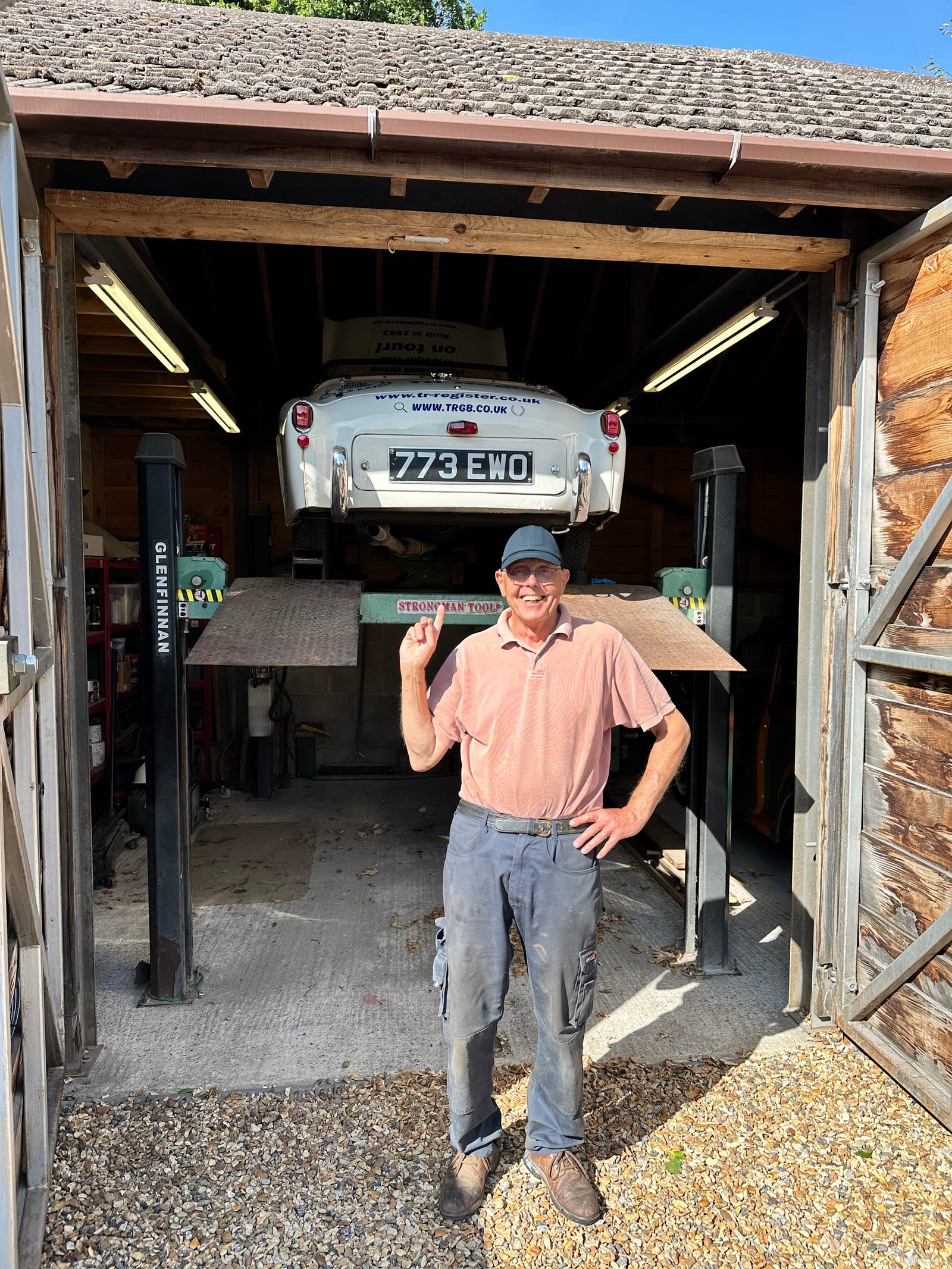 Our host in the doorway of his garage, TS2 raised above and behind him on the four-post lift