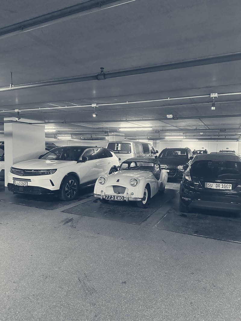TS2 parked in an underground car park in Merano, wedged between two modern SUVs