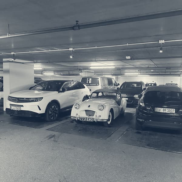 TS2 parked in an underground car park in Merano, wedged between two modern SUVs