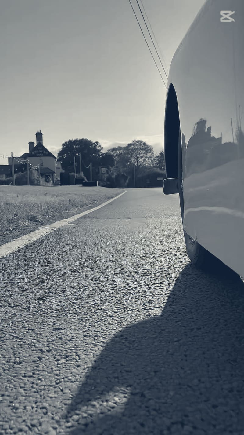 A frame from the 360 camera: low beside TS2's front wing, road and hedgerow running past