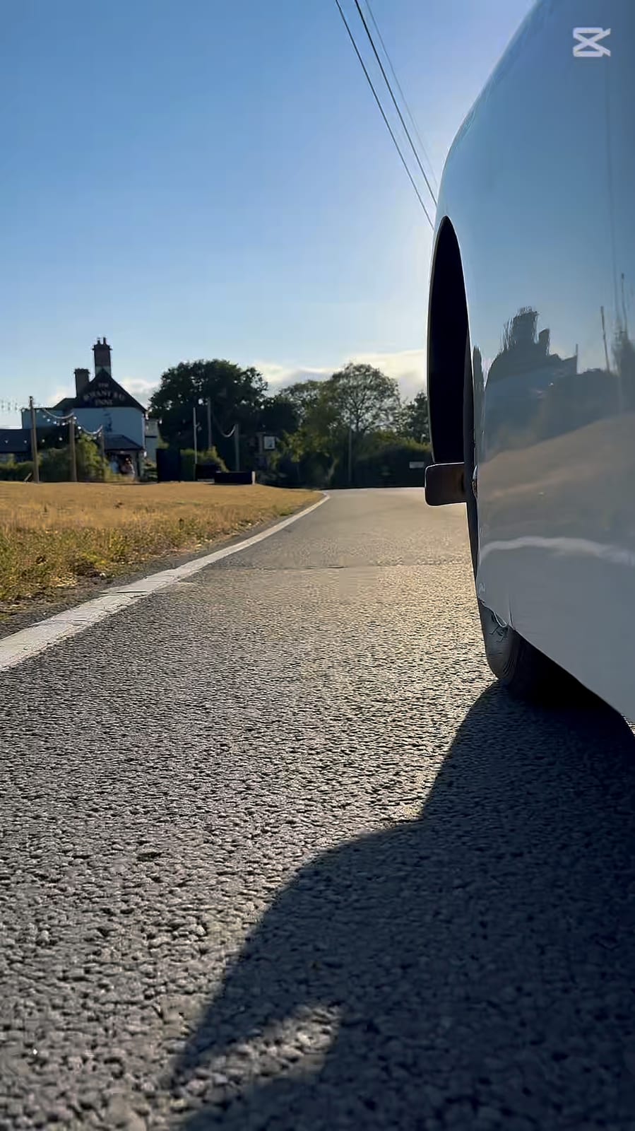 A frame from the 360 camera: low beside TS2's front wing, road and hedgerow running past