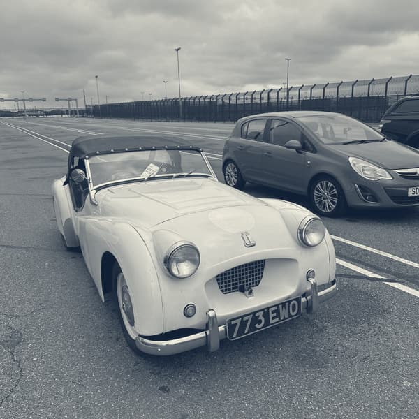 TS2 with her hood up, parked alone in the empty marshalling lanes at Dunkirk under a heavy grey sky, port fencing behind